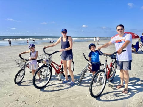Family biking on beach