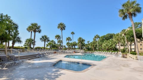 Community pool and kiddie pool with beach access at Captain's Cove