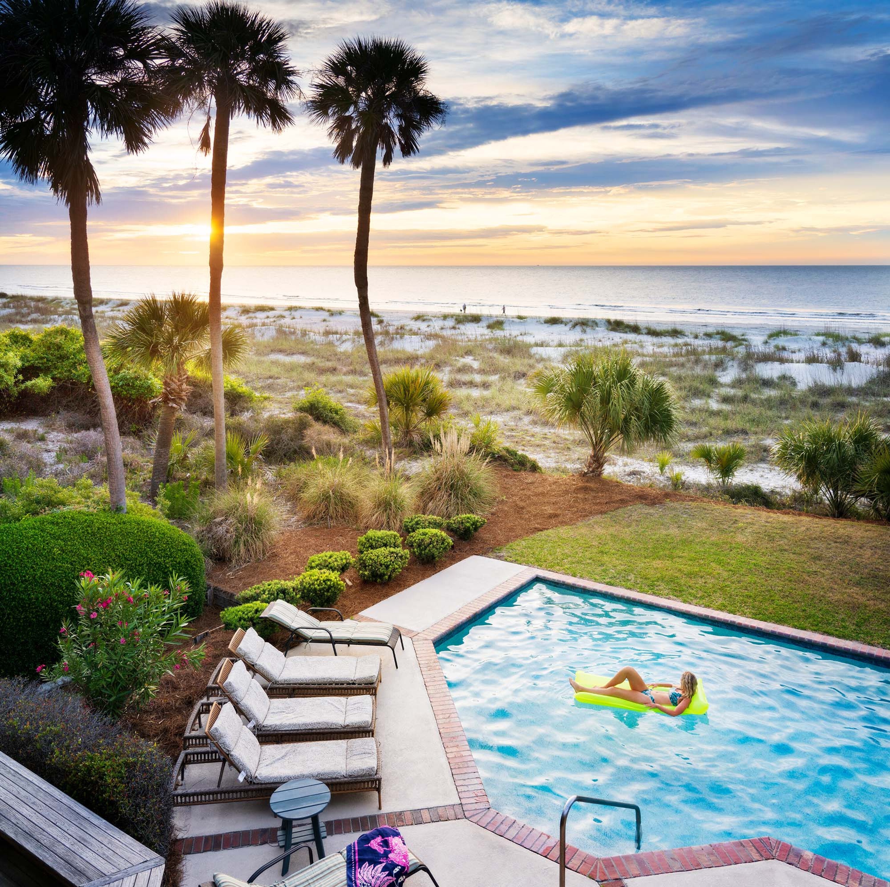 girl floating in a pool at a private vacation rental on the beach