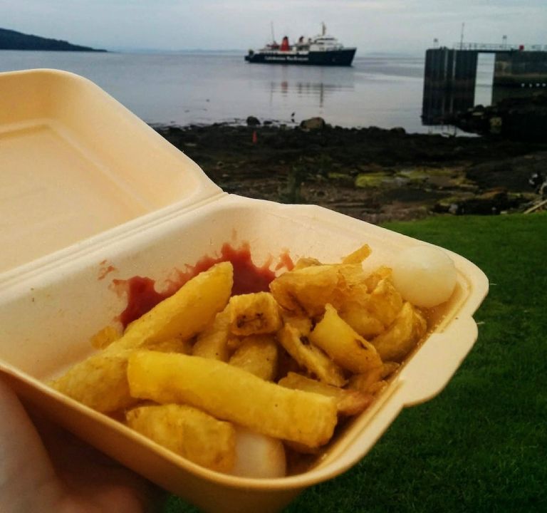 chips on arran with ferry in the background