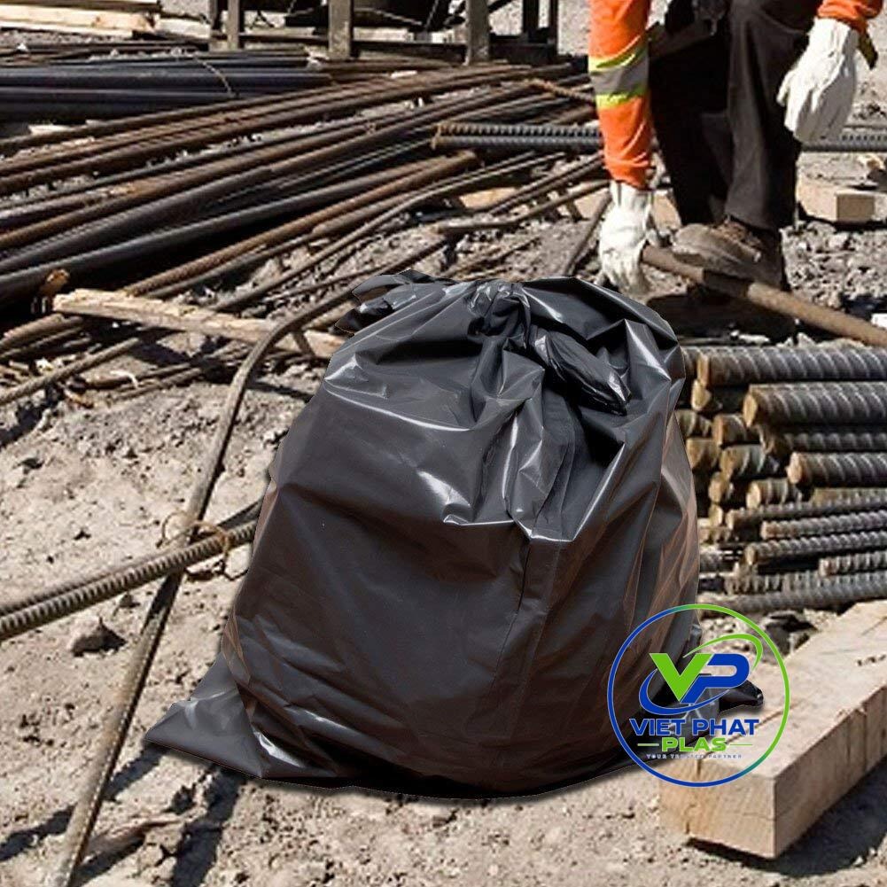 Contractor-grade trash bag holding heavy, sharp-edged construction debris