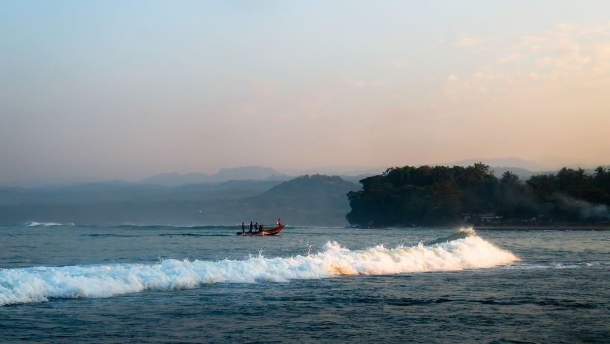 Mentawai Islands fishing boat sunrise boatload surfers heading out