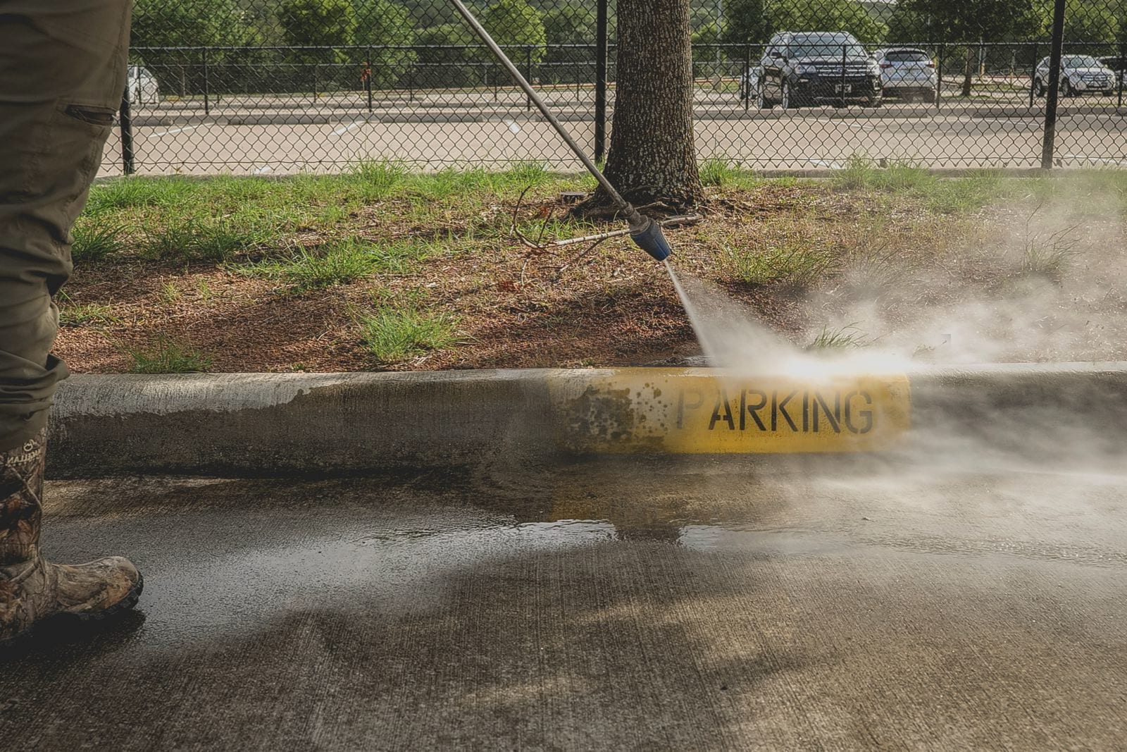 Power washing equipment cleaning asphalt pavement surface