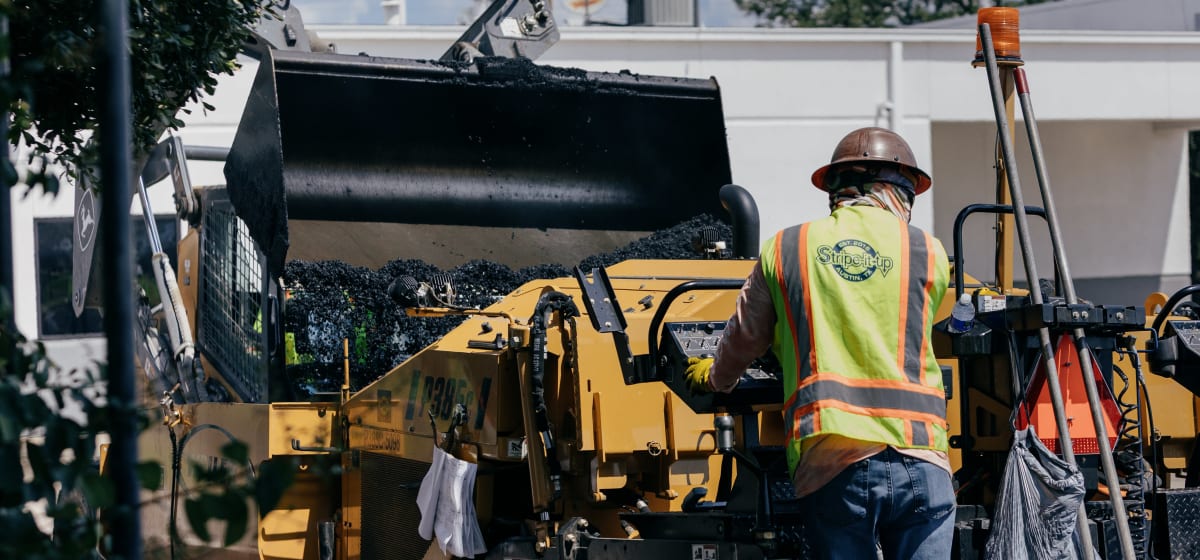 A Stripe-It-Up crew paving a commercial site in Austin.