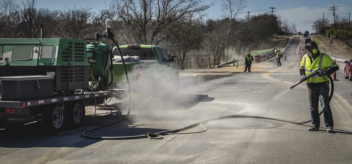 Sandblasting equipment cleaning pavement surface
