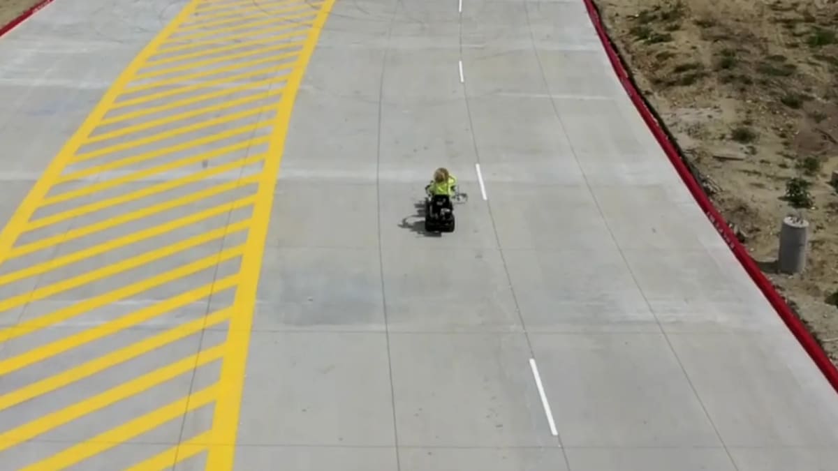 New construction striping machine applying yellow diagonal lines