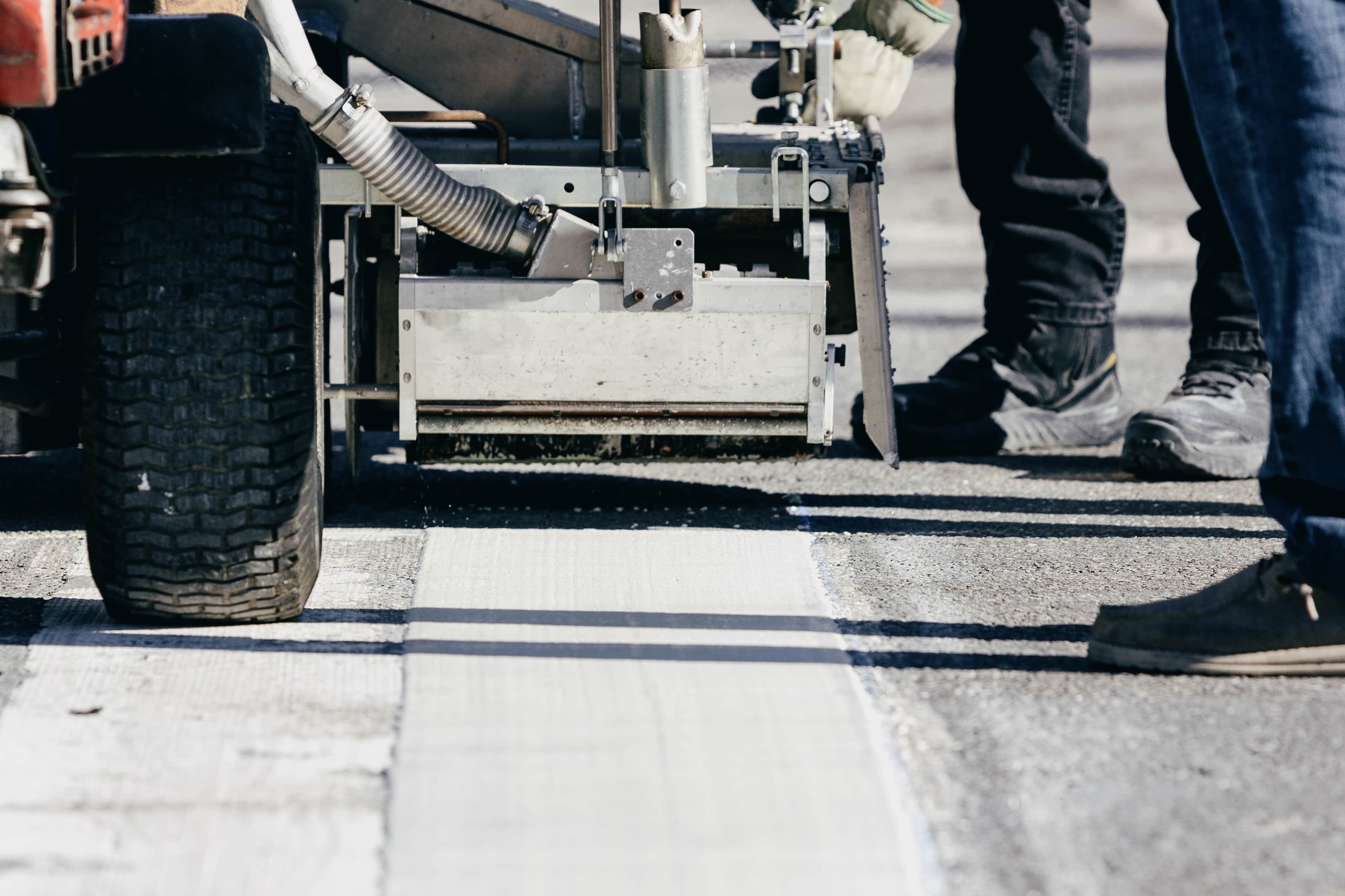 Thermoplastic crosswalk markings being applied over powdered forms in Georgetown, Texas