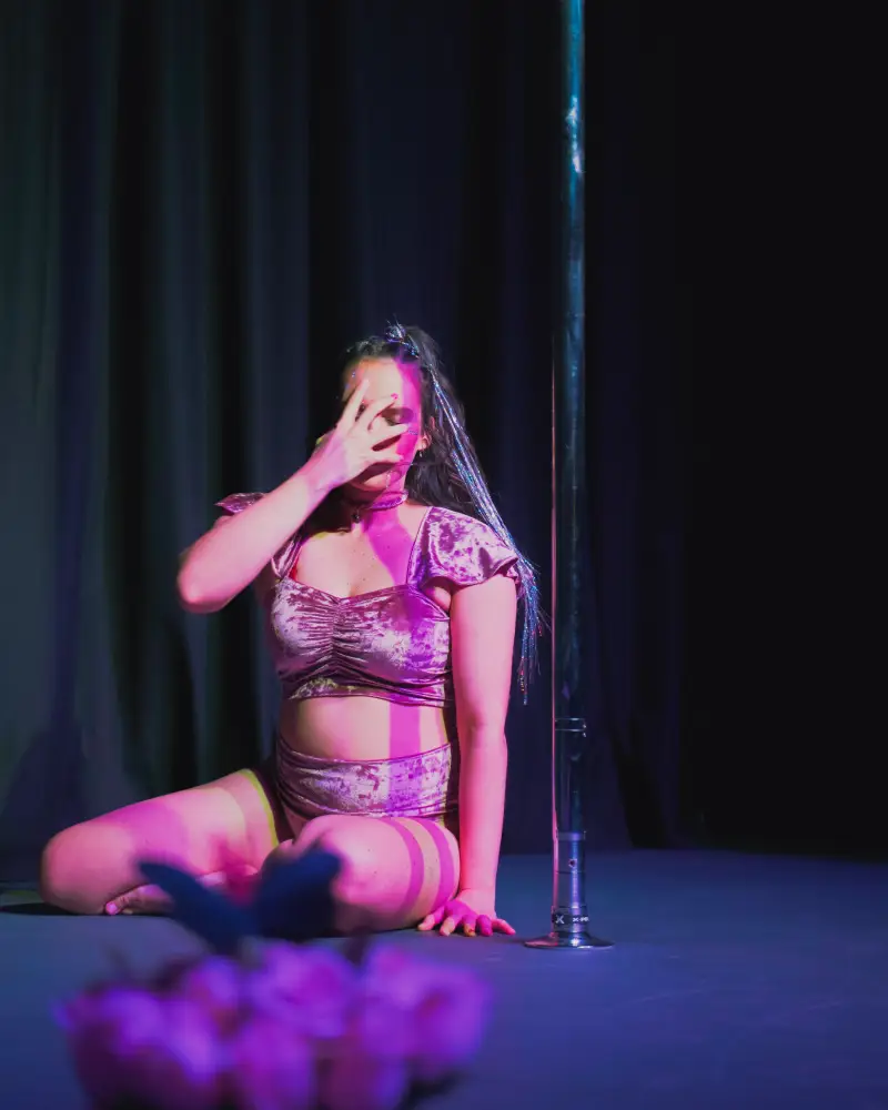 Pole dance performance in elegant lighting