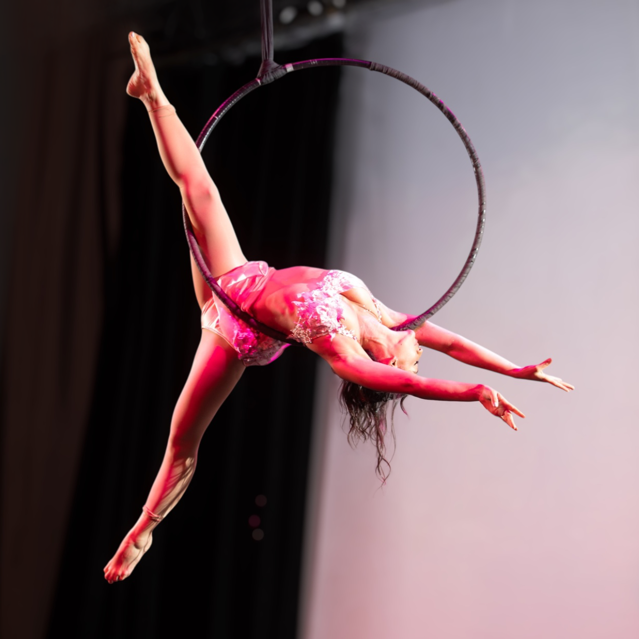 Aerial hoop artist in graceful pose