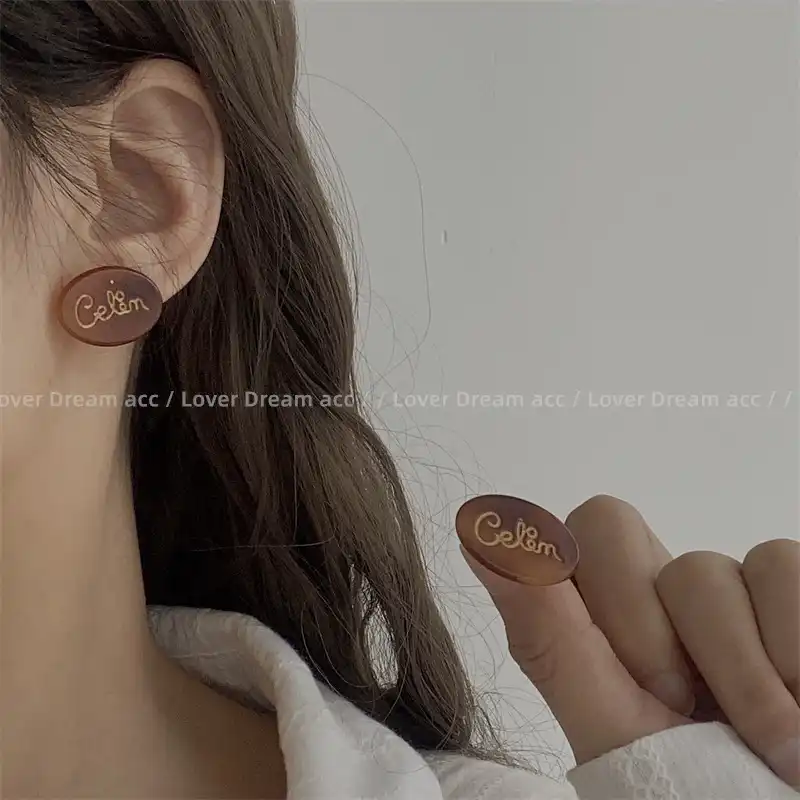 Korean version of gold letter coffee color acetate oval earrings