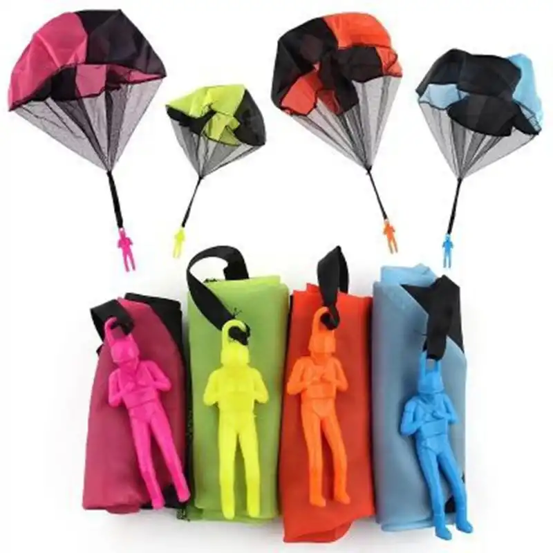 Children throw parachute toy with soldier parachute outdoor sports