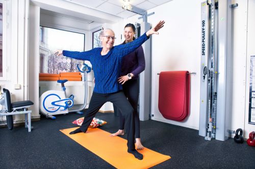 A physiotherapist instructing a patient during exercise.