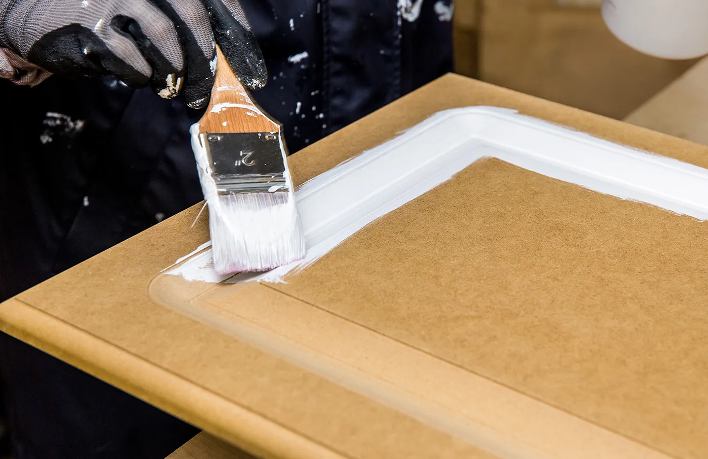 Repainting kitchen cabinet doors with white chalk paint indoors at home