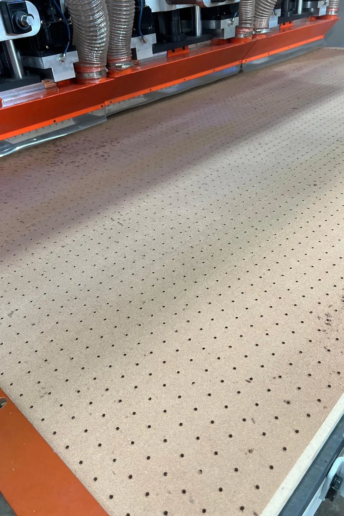 Pegboard being cut by an industrial machine