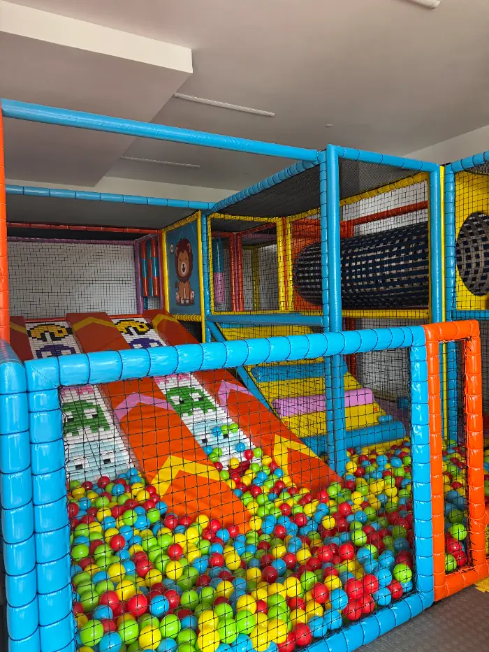 A safe children's soft playground with a colorful ball pool, slides and climbing areas.
