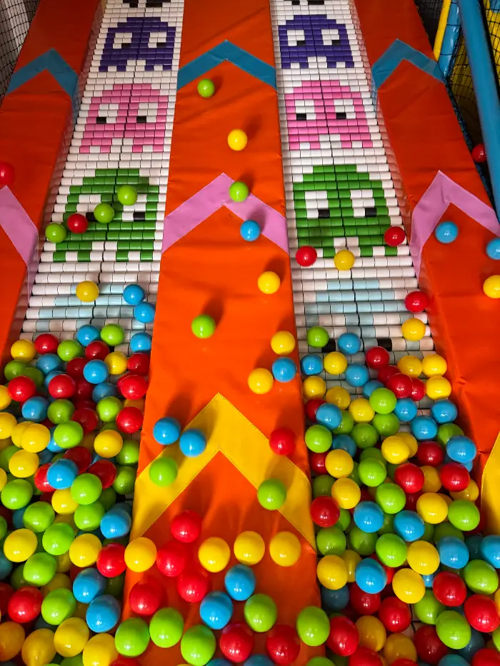 A safe children's soft playground with a colorful ball pool, slides and climbing areas.