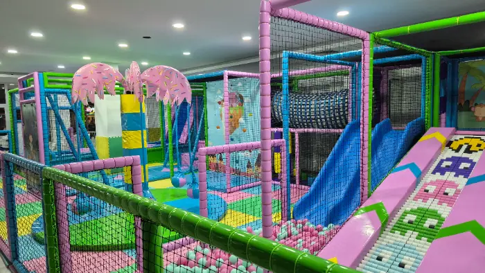 Rengarenk kaydıraklar, top havuzu ve tırmanma alanlarıyla dolu, çocukların güvenle eğleneceği modern bir soft play alanı.