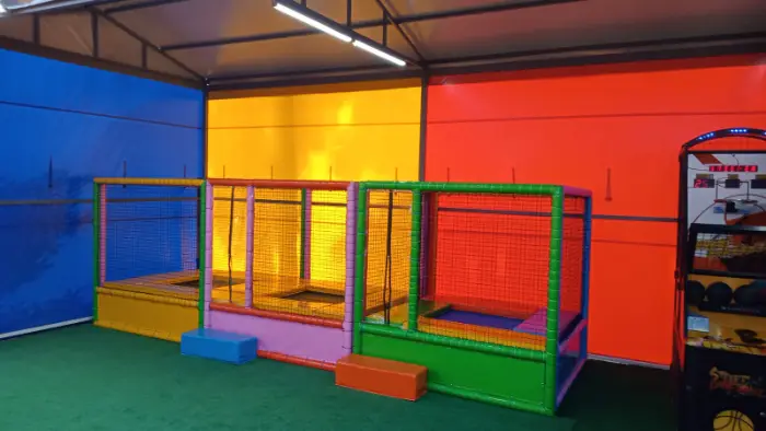 Located on a green background, framed trampoline parks in different colors and a basketball arcade game.