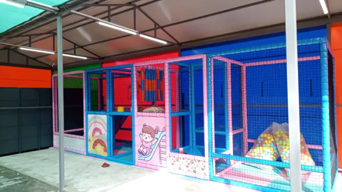 Light blue and pink colored indoor playground decorated with visuals.