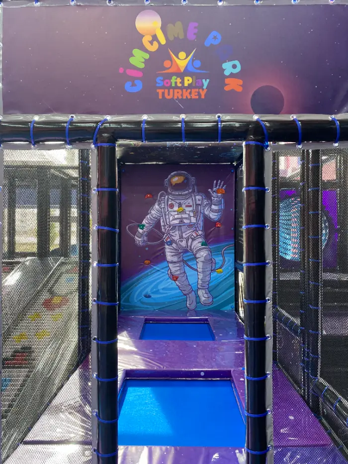 Soft play entrance or tunnel area where the 'Cimcime Park Soft Play Turkey' logo and astronaut-figure wall panel floating in the air are prominent.