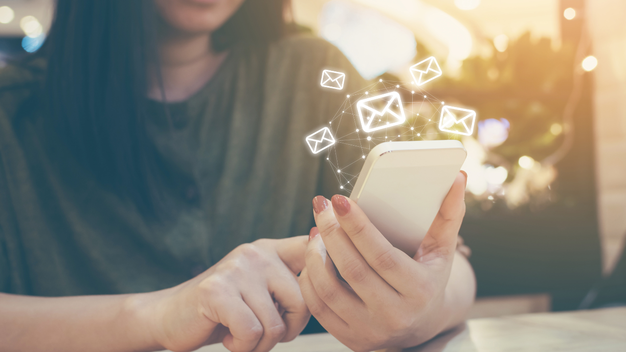 Woman sending or receiving emails through phone