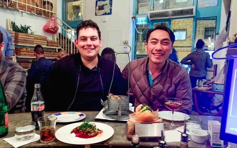Alex Lin-Goldsmith at dinner with his husband Danny on their Birthright Israel trip