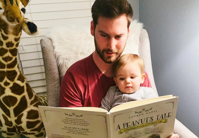 Connor with his nephew reading a book