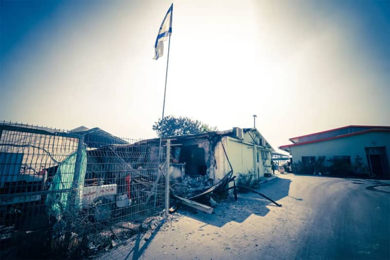 An Israeli flag flies high in a kibbutz in Southern Israel following the October 7 attack