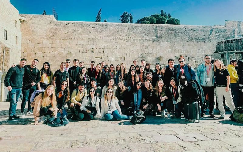 Snir Lasri with his Birthright Israel group at the Kotel in 2019