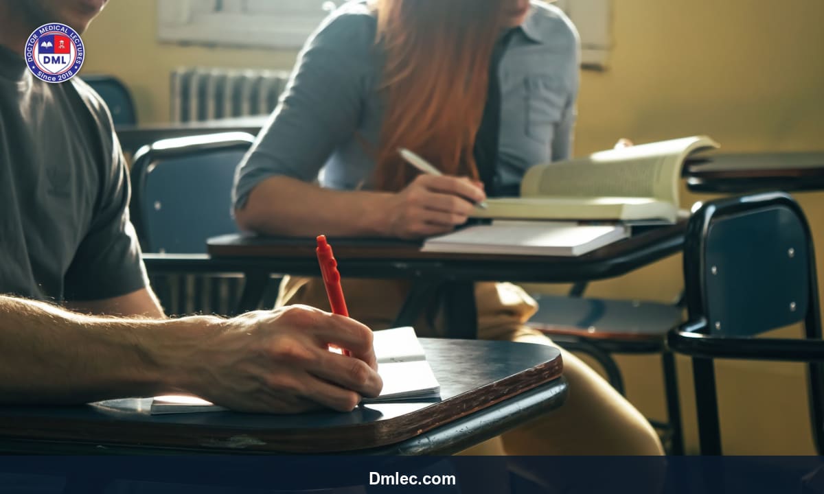 Medical student studying with textbooks, laptop, and notes on desk