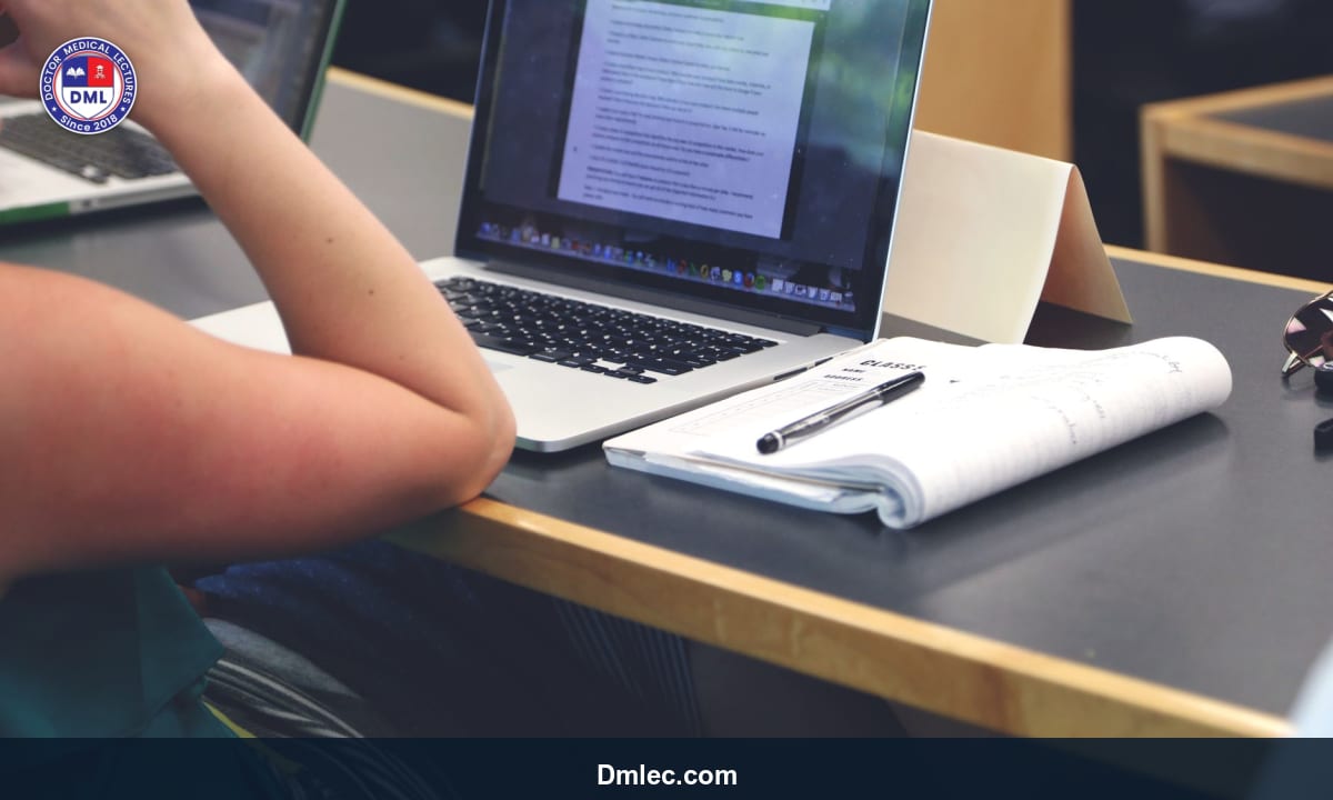 Medical student attending an online lecture on a laptop in a quiet study area