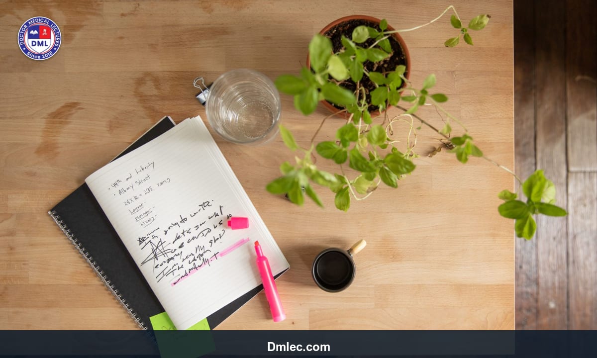 Close-up of study notes highlighted with colorful markers and a pen on a desk