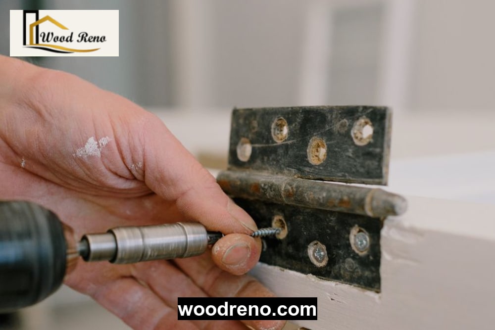 Close-up of a skilled carpenter fixing wooden door hinges and applying eco-friendly polish in Woodreno workshop