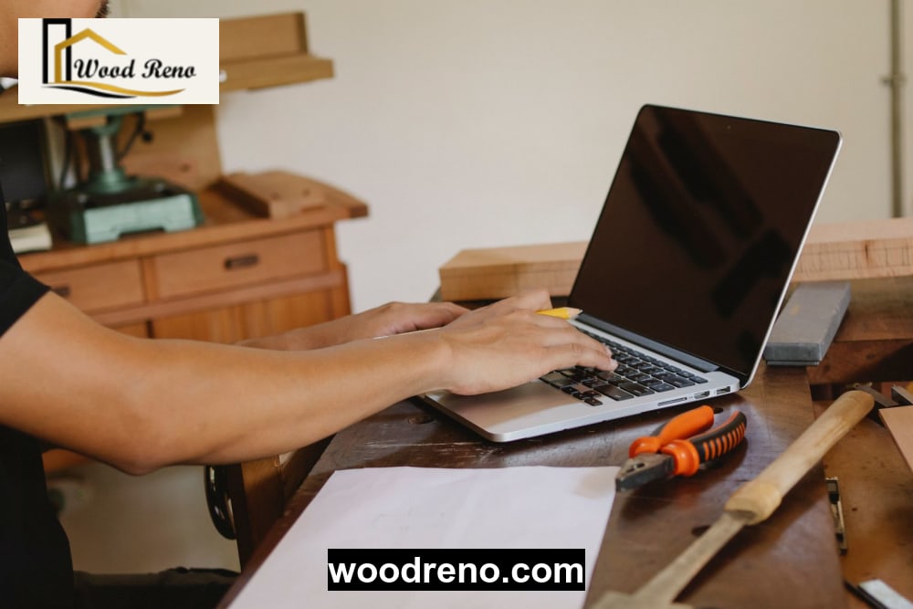 Woodreno artisan customizing a bespoke wooden computer table inside a traditional Pakistani woodworking workshop