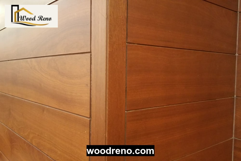 Professional installing wood wall panels inside a Pakistani home, demonstrating careful fitting and finishing techniques