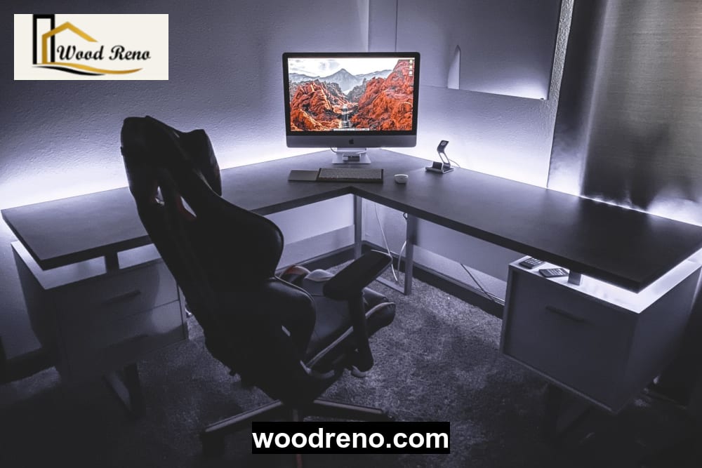 L-shaped computer desk layout showing separate monitor and writing zones in a compact room