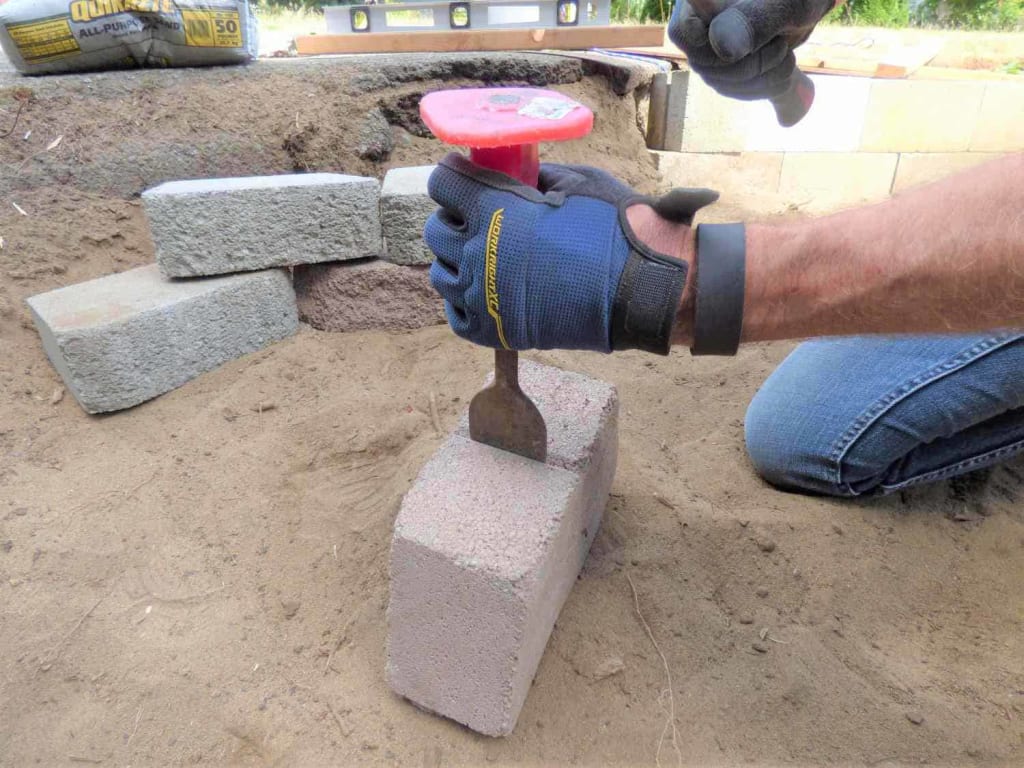 Cut the end stones To Build a Patio Seating Wall