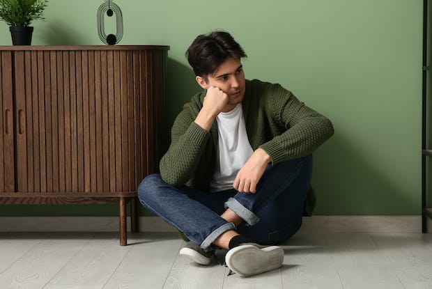 a sad man sitting on the ground