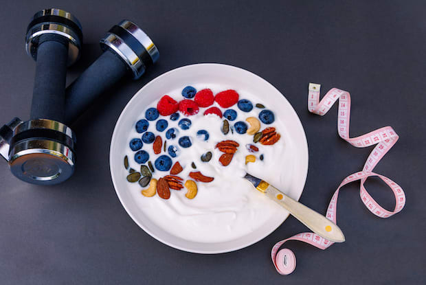 healthy food, gym equipment, and a measuring tape