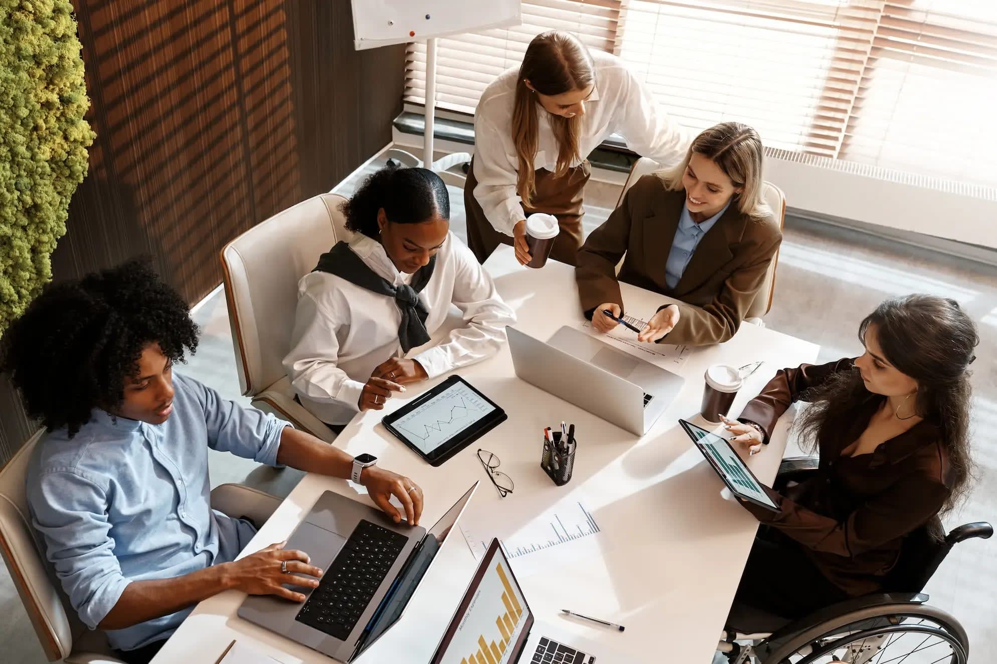 diverse-business-team-analyzing-charts-during-offi-2026-01-11-10-56-35-utc (1).webp