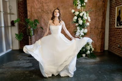The Idra wedding dress with a basque waistline and full chiffon skirt