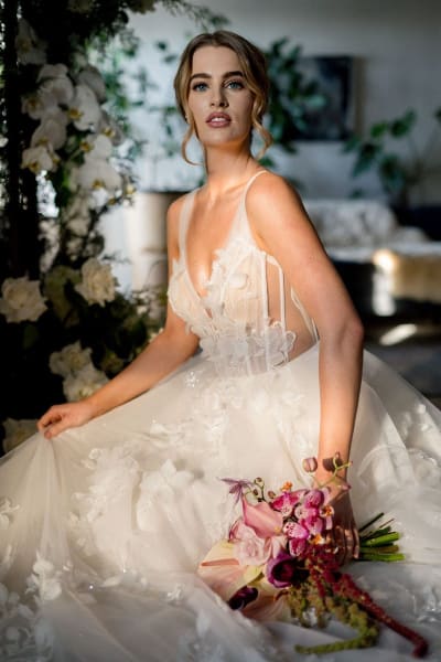 Stunning vneck Aline tulle gown with hand applique lace throughout. Semi-sheer bodice, exposed boning detailing.