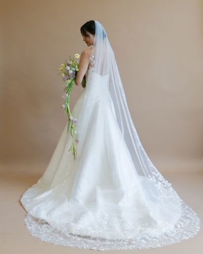 Bride wearing long lace veil