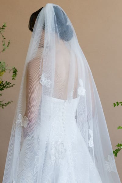 Bride wearing long lace veil