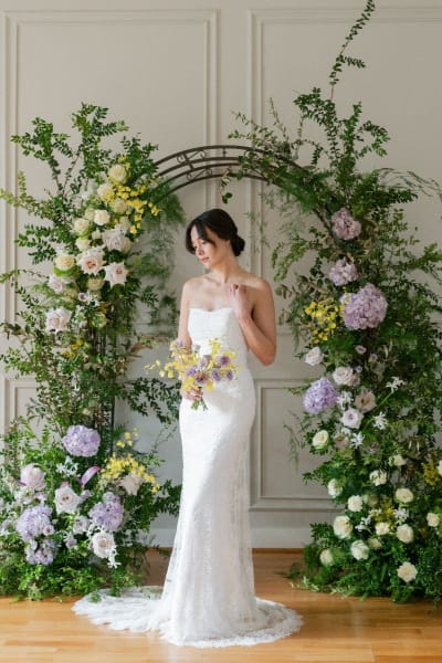 The entire dress is adorned with an intricate, dimensional floral lace pattern.