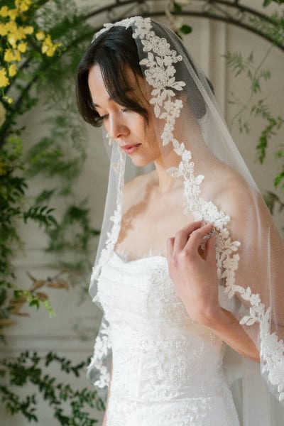 Bride wearing long lace veil