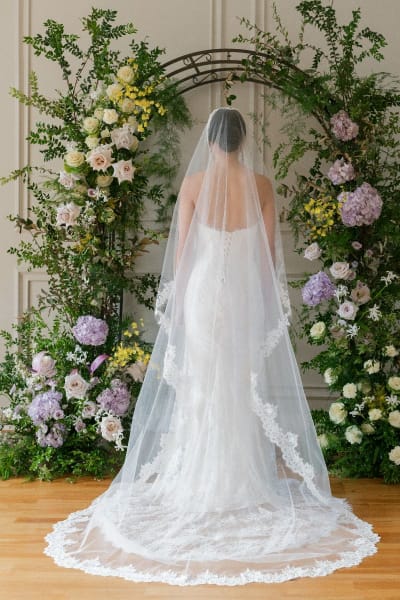 Bride wearing long lace veil