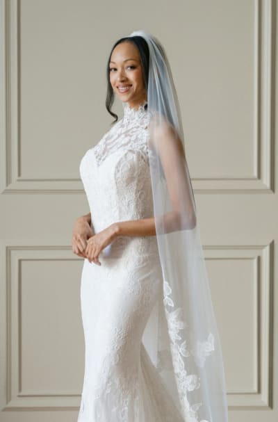 Bride wearing long lace veil