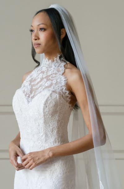 Bride wearing long lace veil