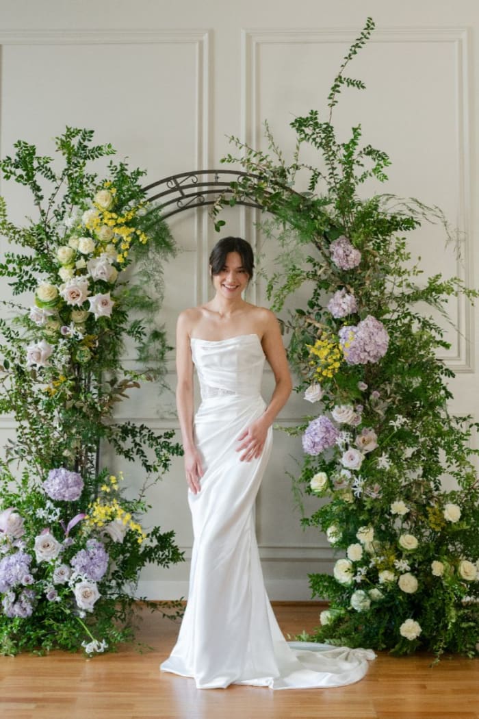 This minimalist satin gown stuns with its sleek lines and curve-enhancing fit-and-flare shape